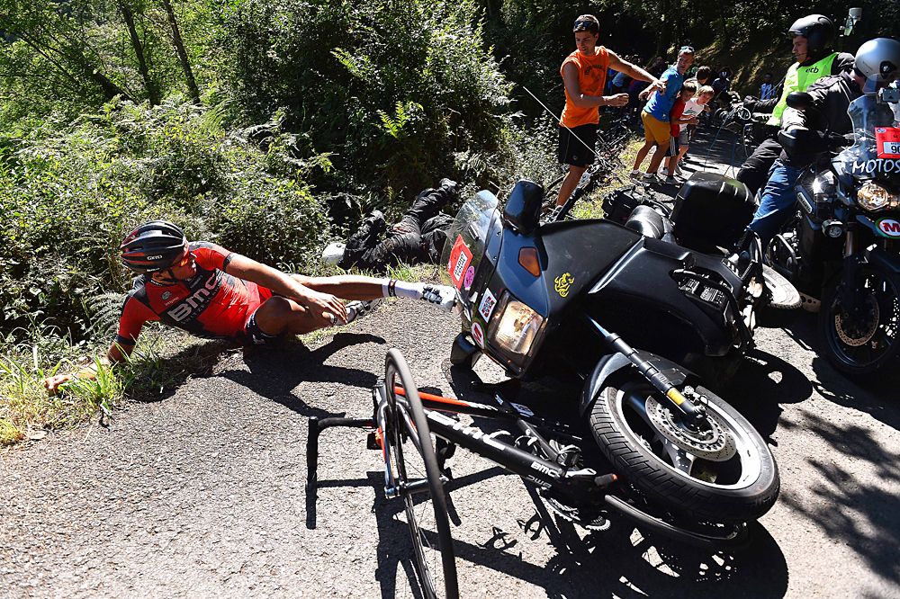 Greg Van Avermaet (BMC) broken bike underneath the TV motorcycle
