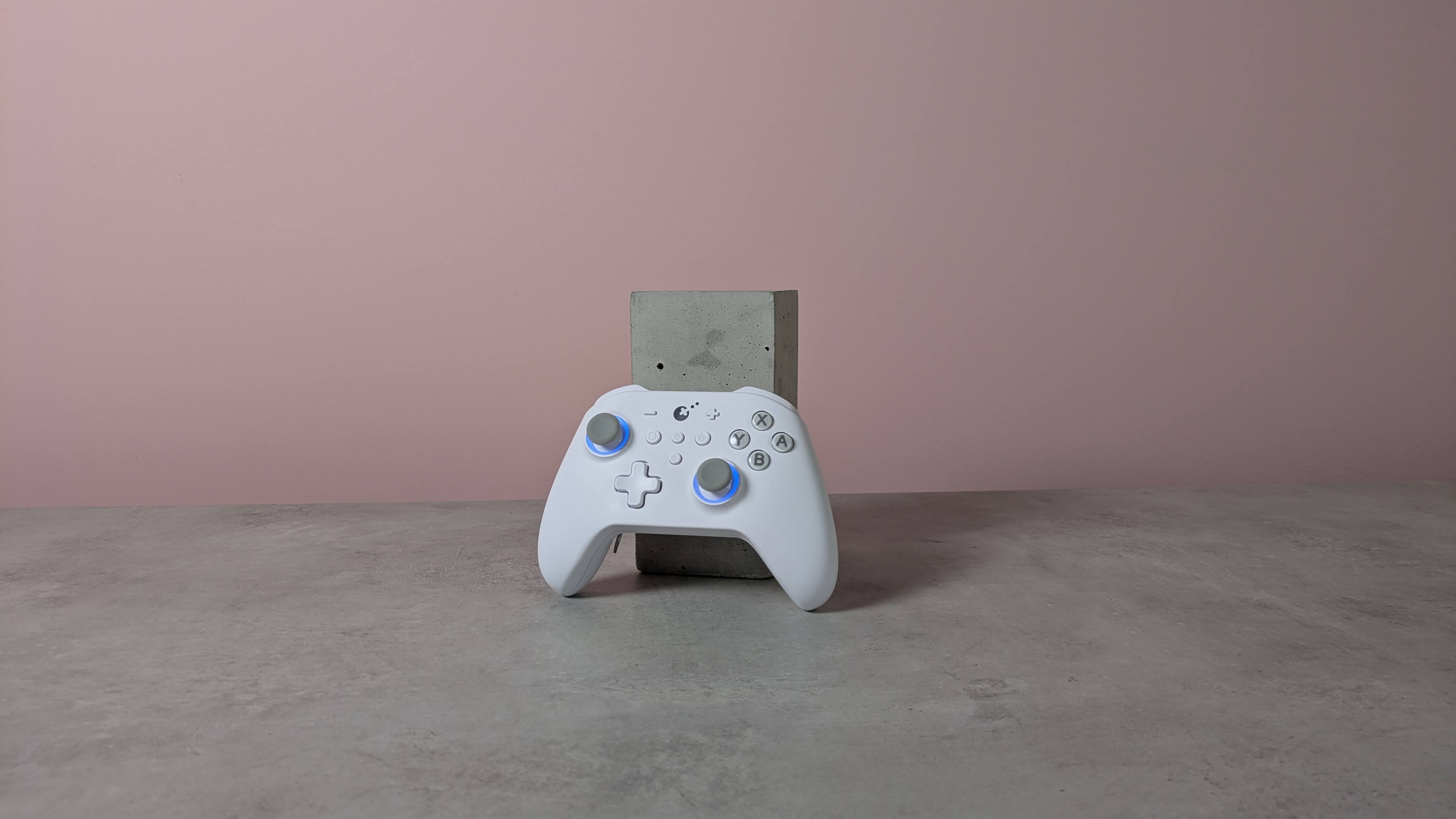 Gulikit KK3 Max leaning on plinth on desk with pink wall in background