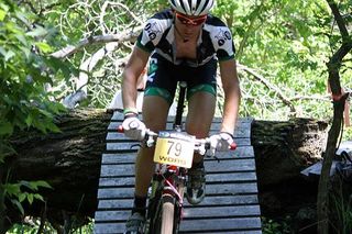 An elite rider crosses a bridge during the Subaru Cup.