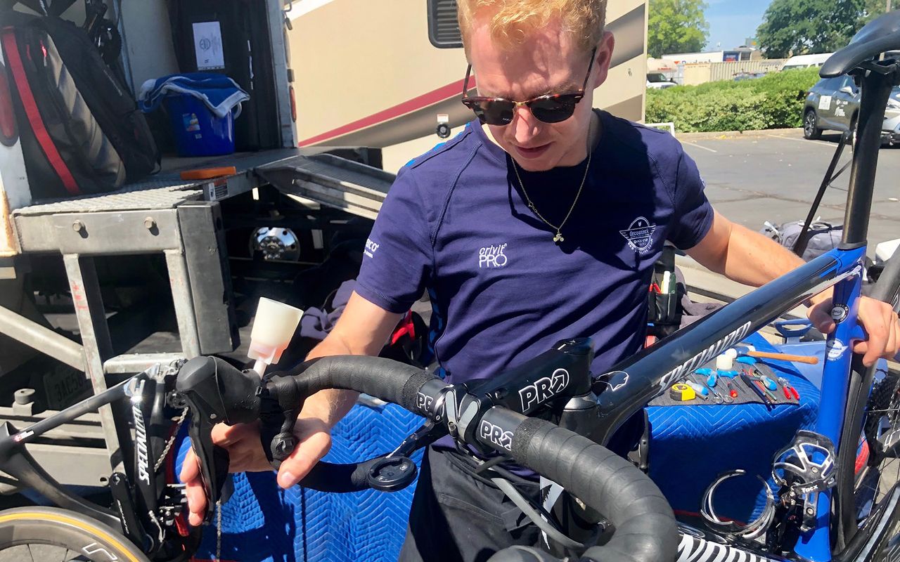 A Deceuninck-QuickStep mechanic bleeds the disc brakes on an S-Works Tarmac ahead of the race