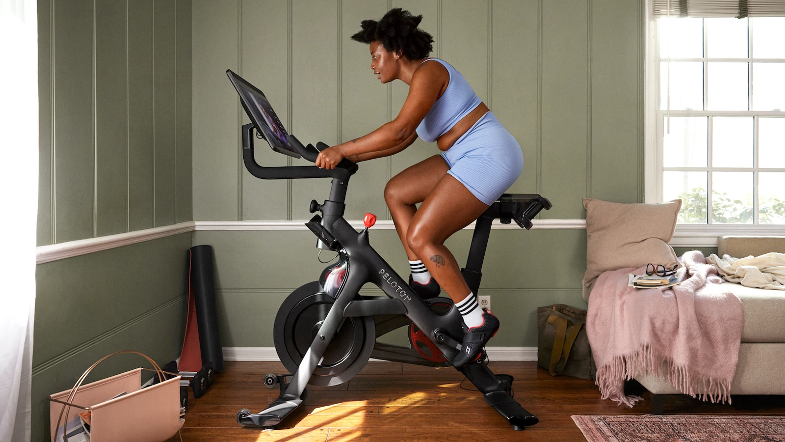 Peloton Bike being ridden by a woman in a house