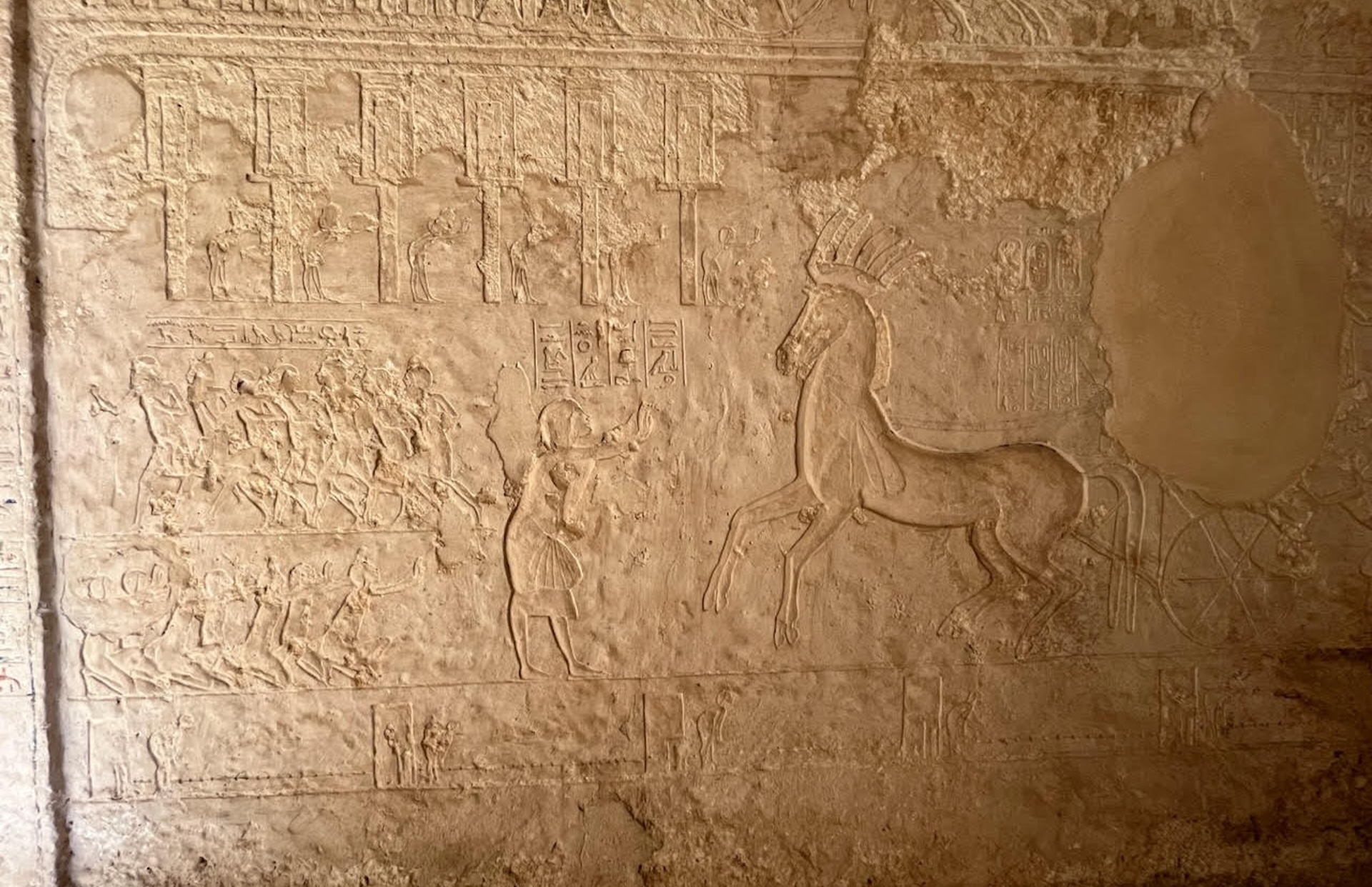 a photo of a wall engraving in a tomb showing various scenes