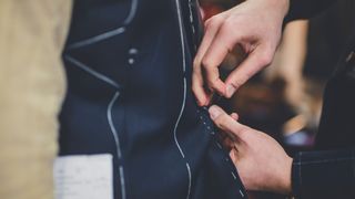 person tailoring blazer