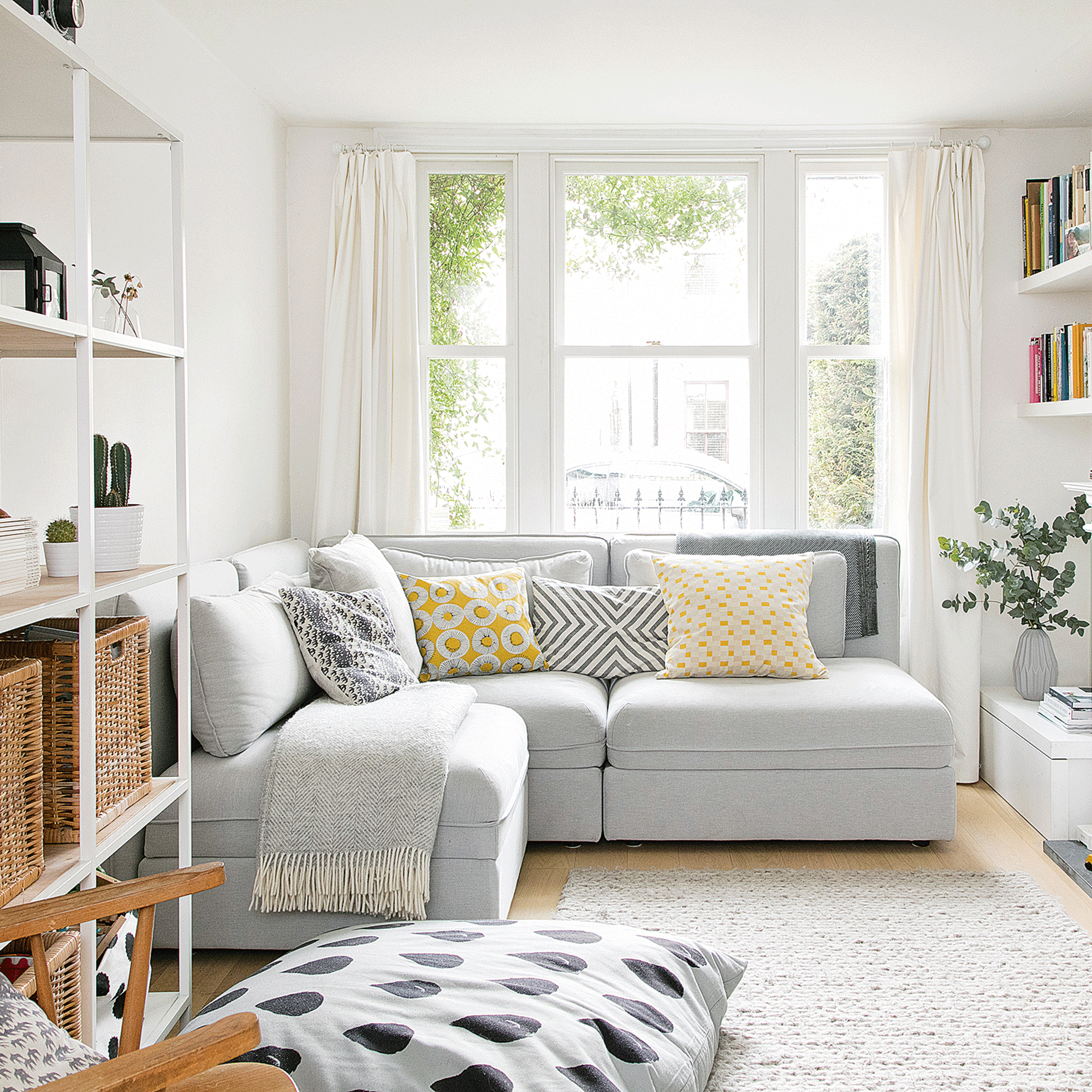Grey modular corner sofa in small white living room 