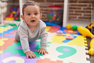 crawling baby on a playmat at nursery to illustrate the rollout of the 15 hours free childcare scheme to nine month olds