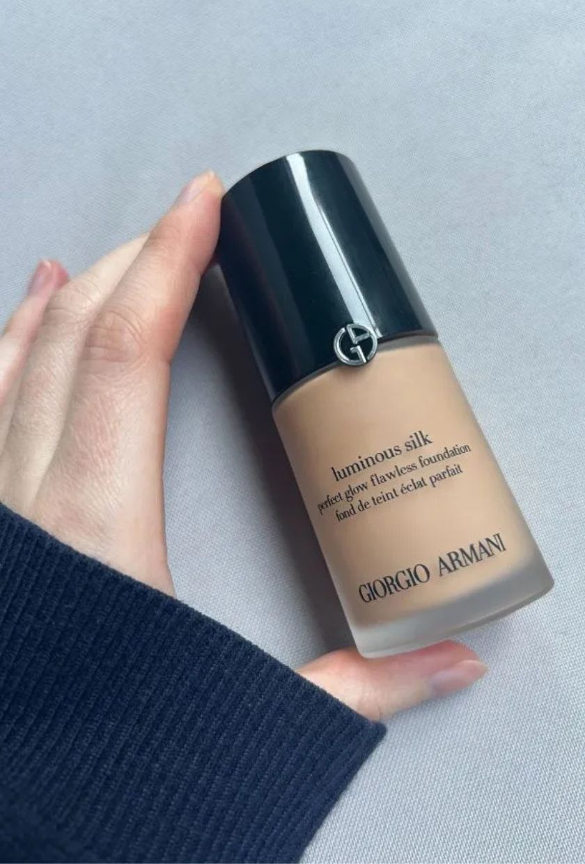 Grace holding a bottle of Armani Luminous Silk