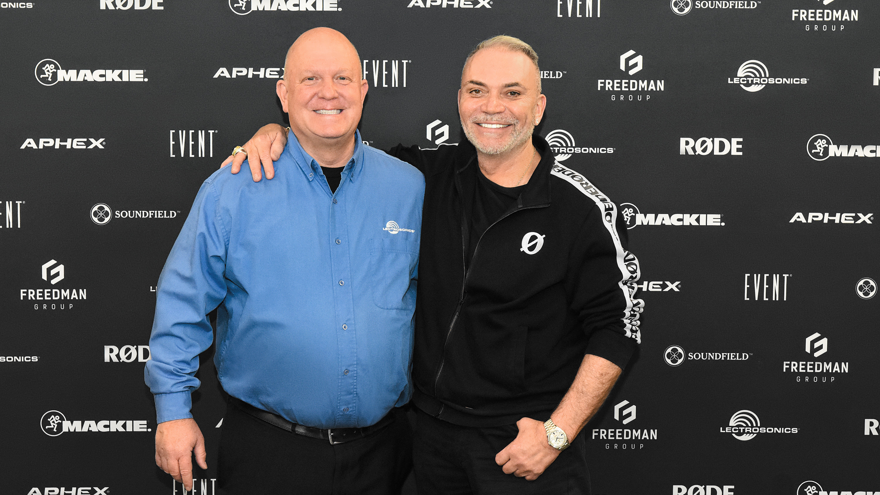 Leaders from Lectrosonics and the Freedman Group embrace. 