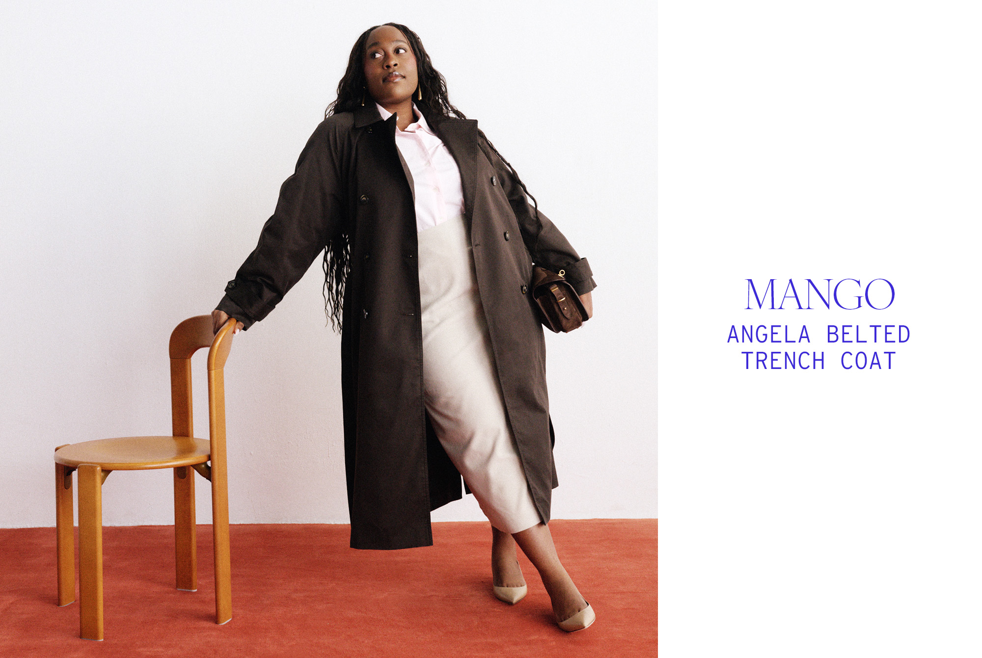 Aniyah wears a brown trench coat, button-down shirt, and beige skirt.