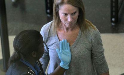 A passenger gets a pat-down after going through the full-body scan at O'Hare airport in Chicago. The TSA is reportedly making small changes to the new rules.