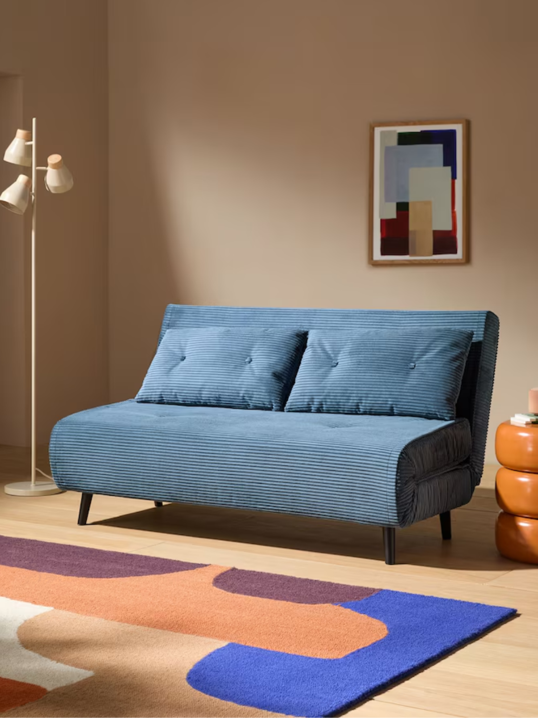 A blue corduroy two-seater sofa