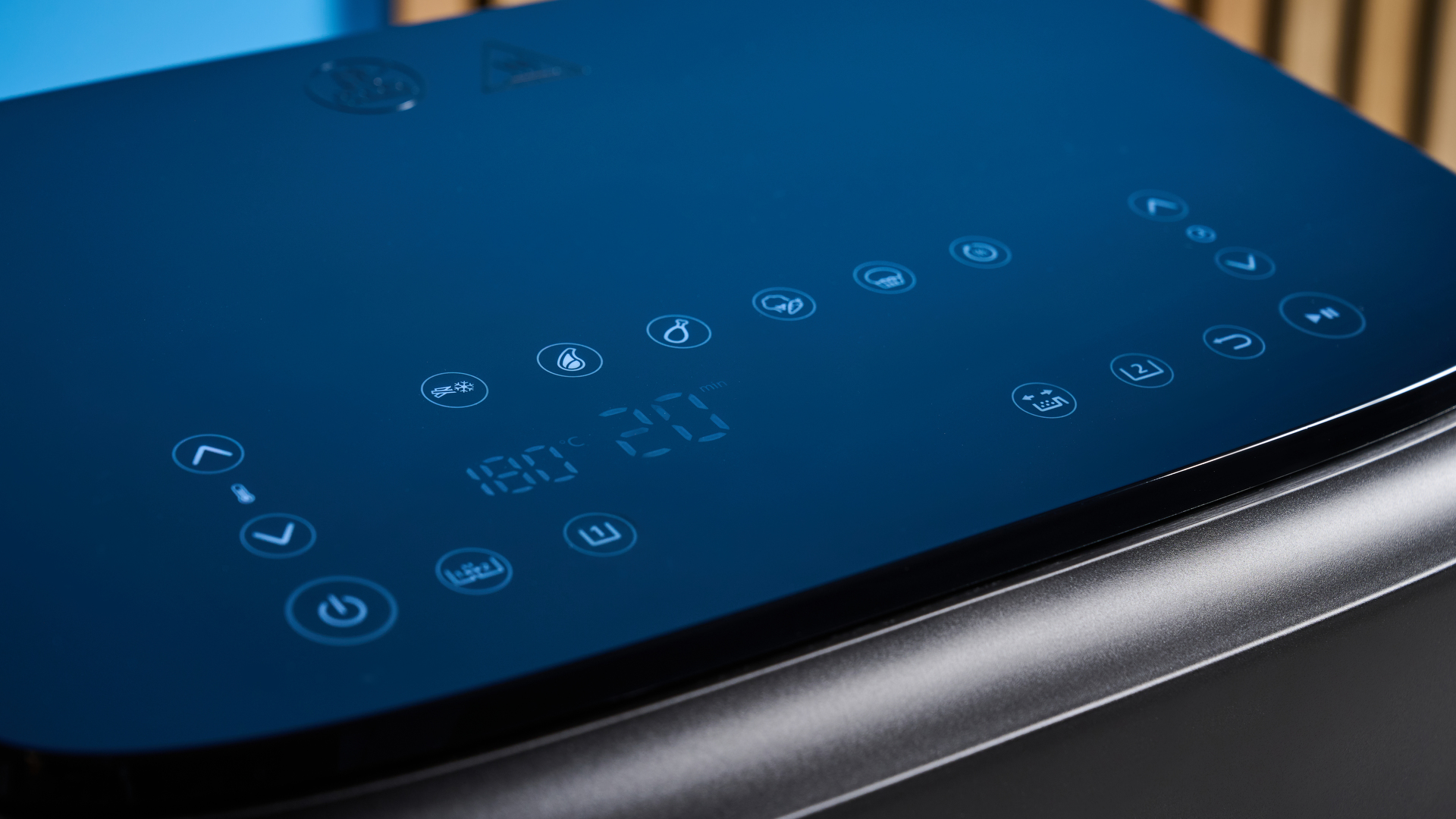 The presets and controls of the Philips 1000 Series FlexDrawer Air Fryer photographed in front of a blue background.