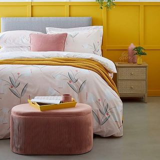 bright bedroom with pink ottoman