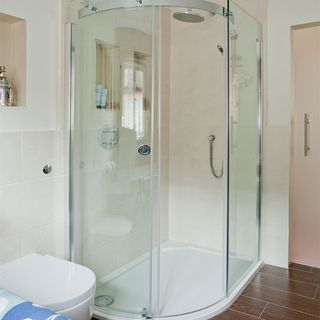 bathroom with vanity unit and glass shower unit