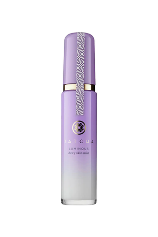 An ombre purple closed bottle of TATCHA luminous dewy skin mist against a white background.