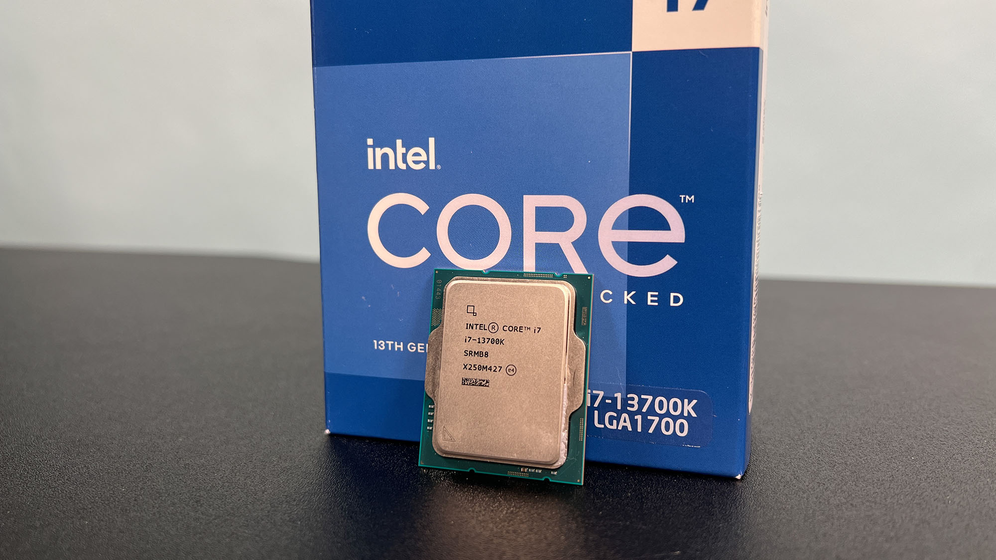 An Intel Core i7-13700K against its retail packaging