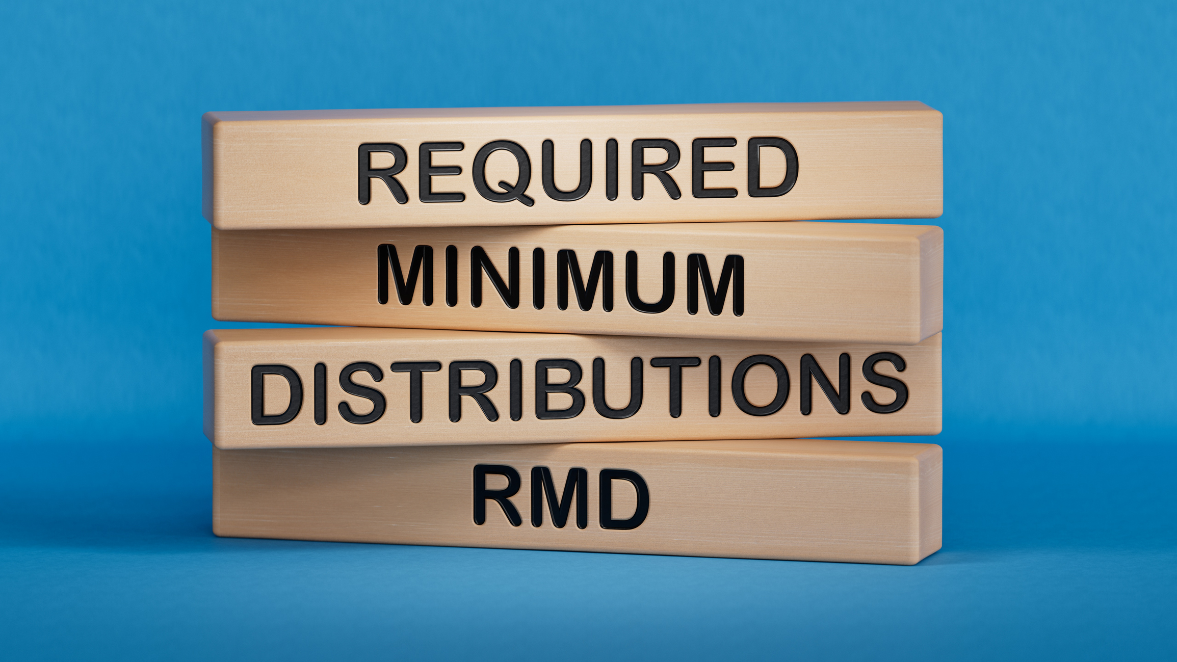 wooden blocks that spell &quot;required minimum distributions&quot; and &quot;rmd&quot;