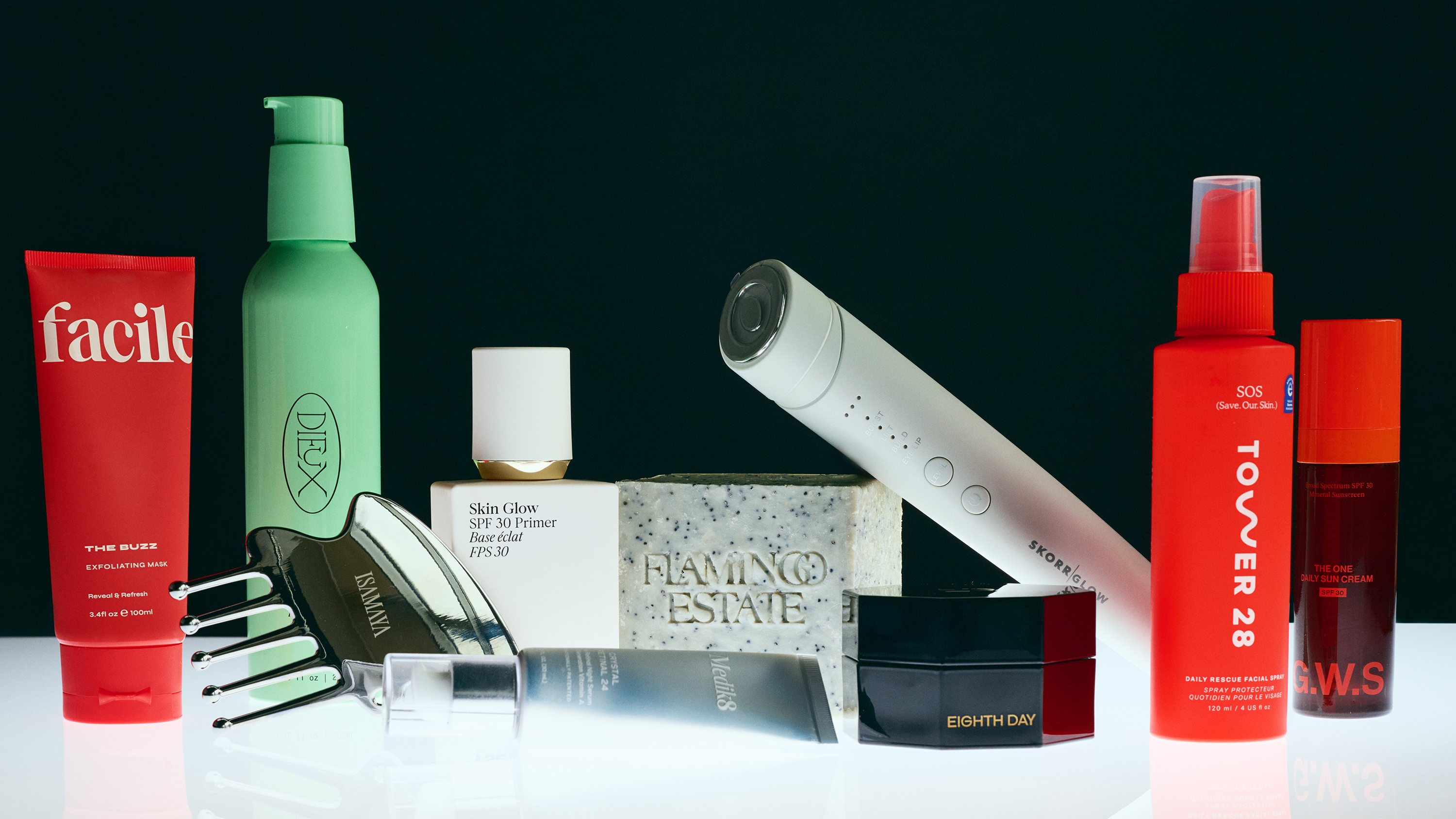 some of the winning skin and hair awards products including tower 28 hairspray and flamingo estate soap on a black background