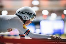 Katie Archibald riding inside a velodrome wearing GB kit