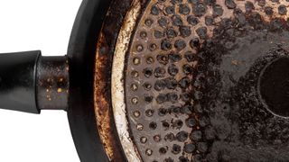 Underside of dirty frying pan