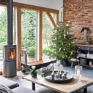 log burner in open plan seating area with Christmas tree