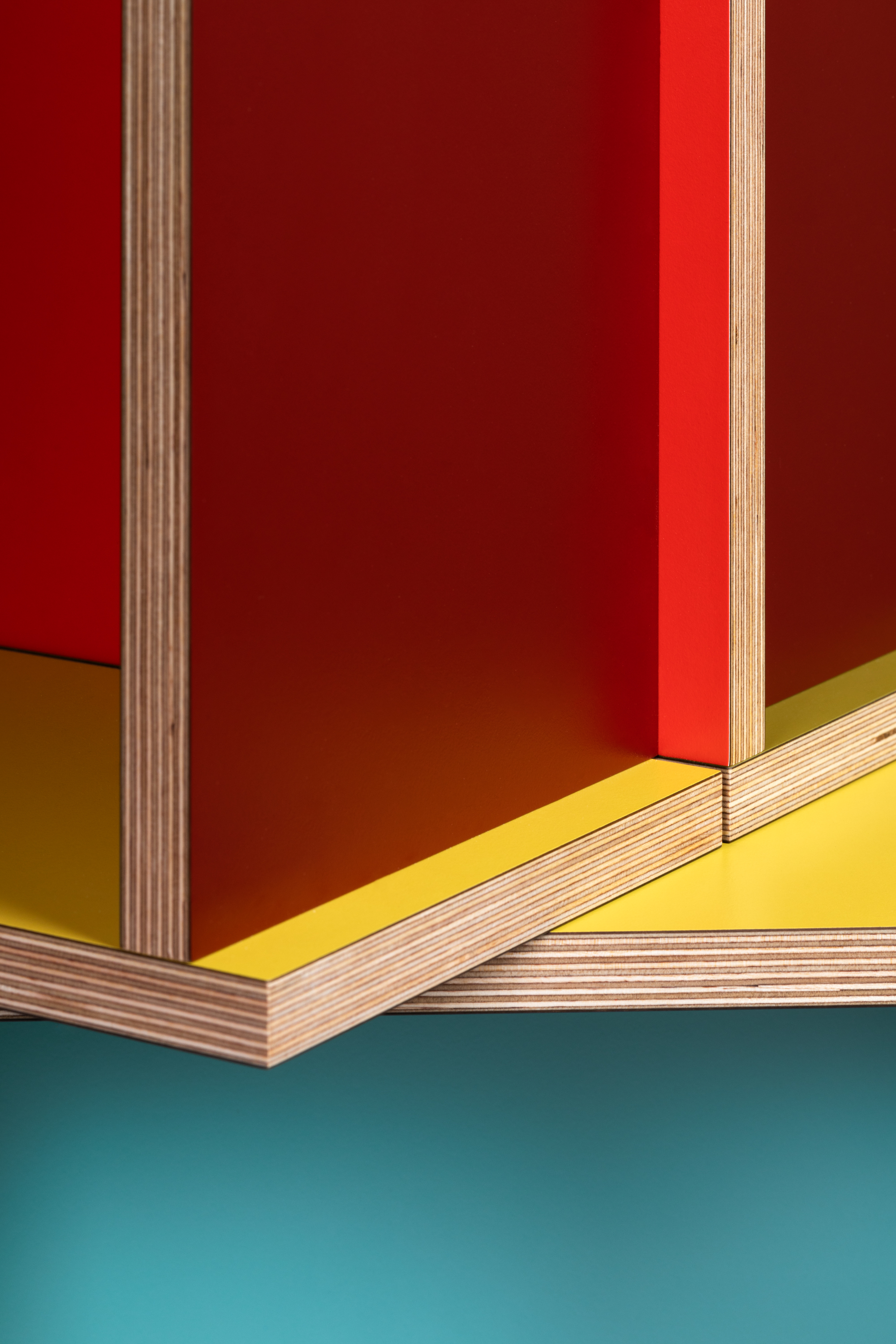 Tables made of colourful plywood sections intersected, made by Sophie Smallhorn for Uncommon projects