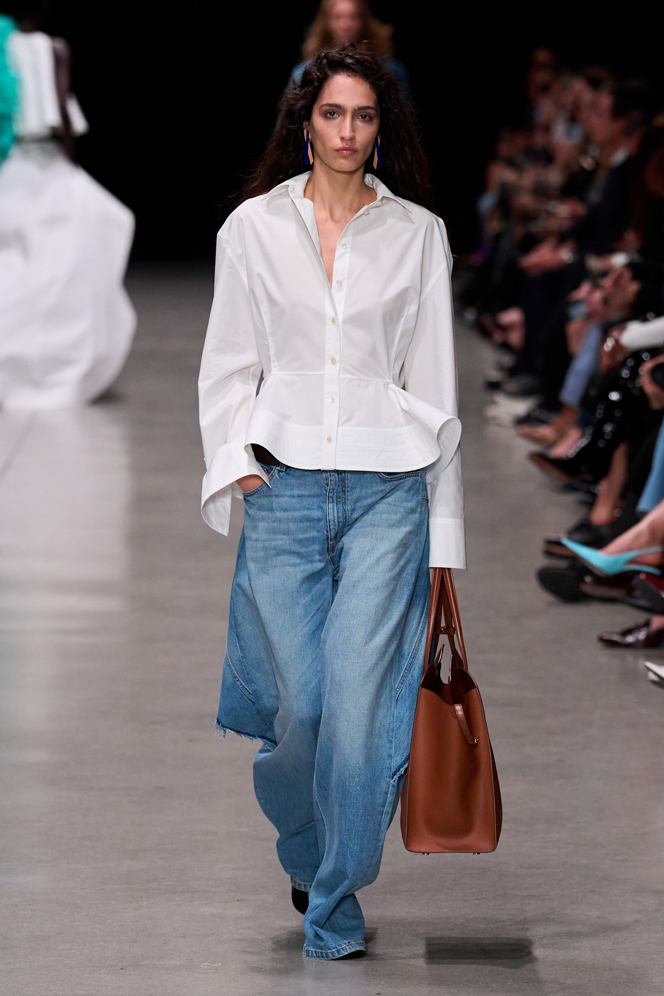 A model wore a denim skirt over jeans on the Stella McCartney Spring 2026 runway