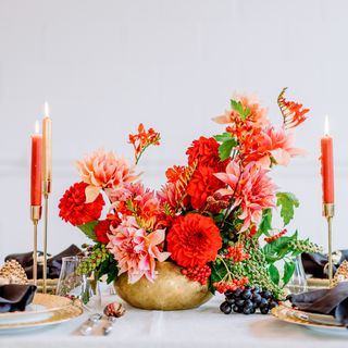 white table with flower vase and red candles