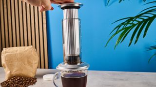 a glass AeroPress premium with aluminum flourishes