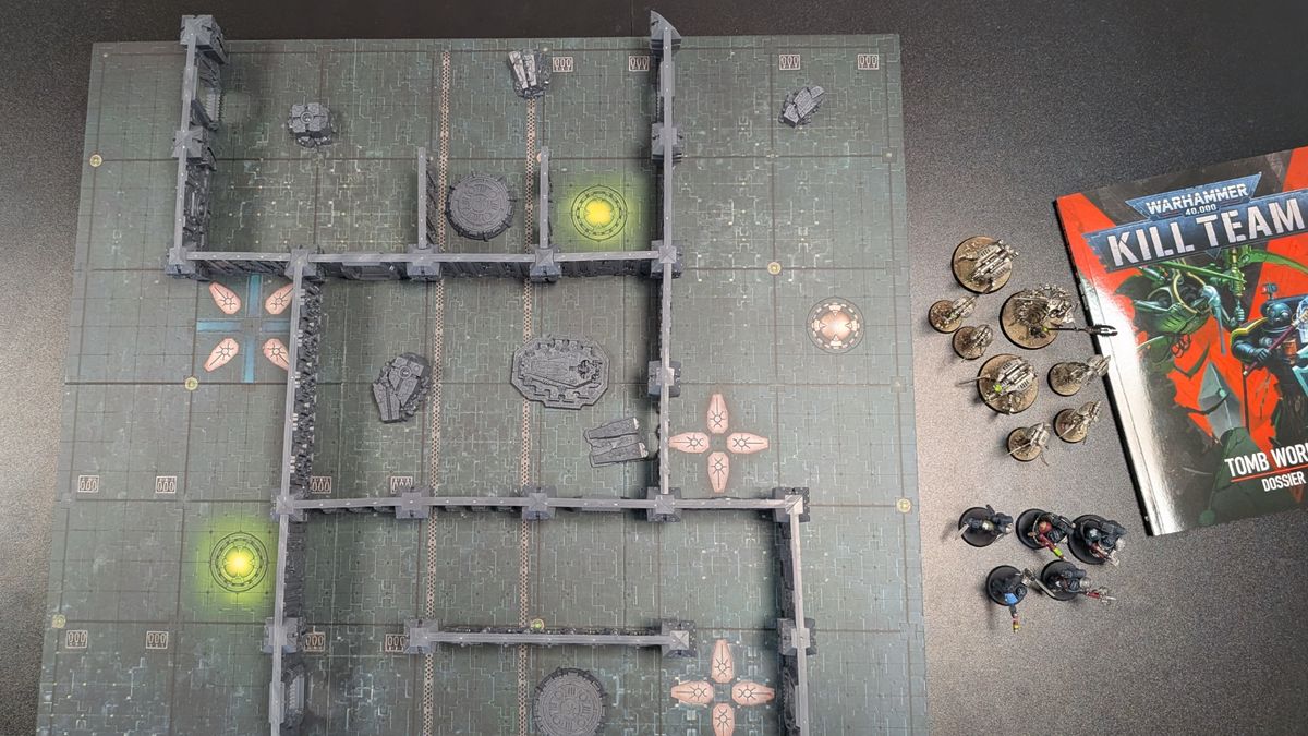 Kill Team: Tomb World board, terrain, miniatures, and book on a dark surface
