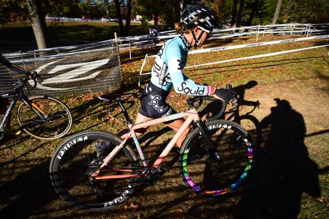 Emily Kachorek (Squid Bikes) running uphill after the barriers