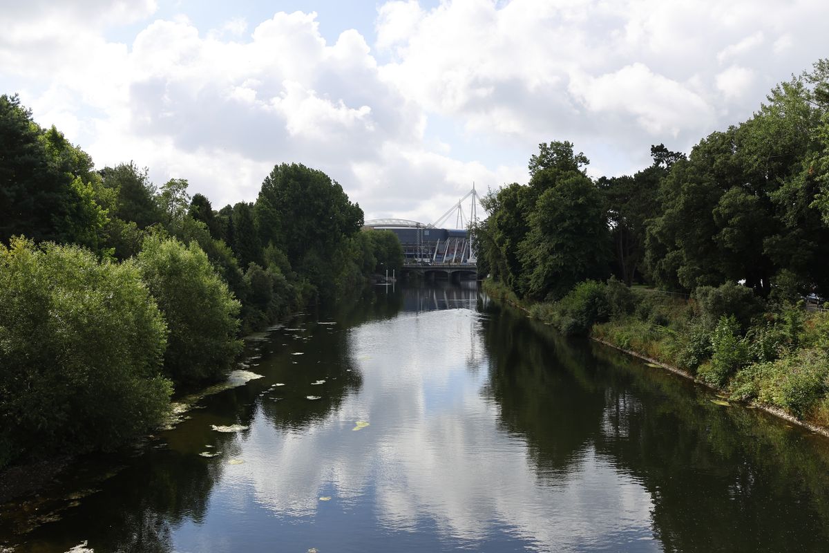 A river running towards a stadium