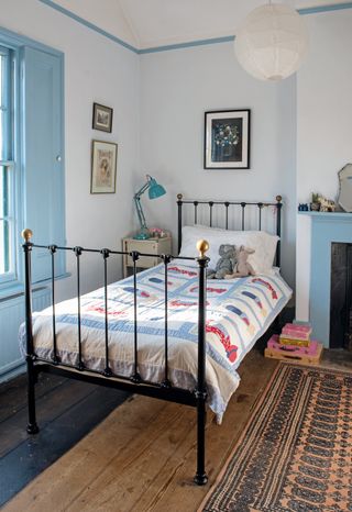 child's bedstead in a Georgian home with blue woodwork