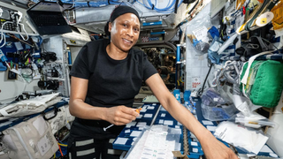 NASA astronaut Jeanette Epps processes blood and saliva samples aboard the International Space Station's Harmony module.