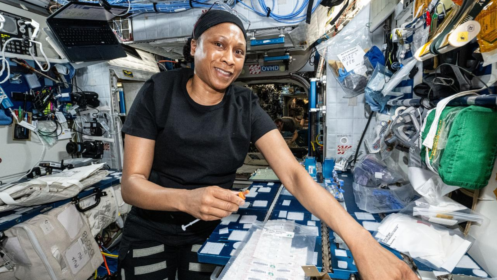 NASA astronaut  Jeanette Epps processes blood and saliva samples aboard the International Space Station's Harmony module.