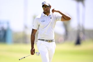 Aaron Rai adjusts the collar on his shirt