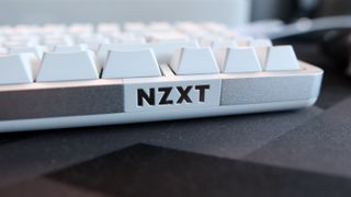 NZXT Function Elite MiniTKL with RGB lighting enabled on a desk.