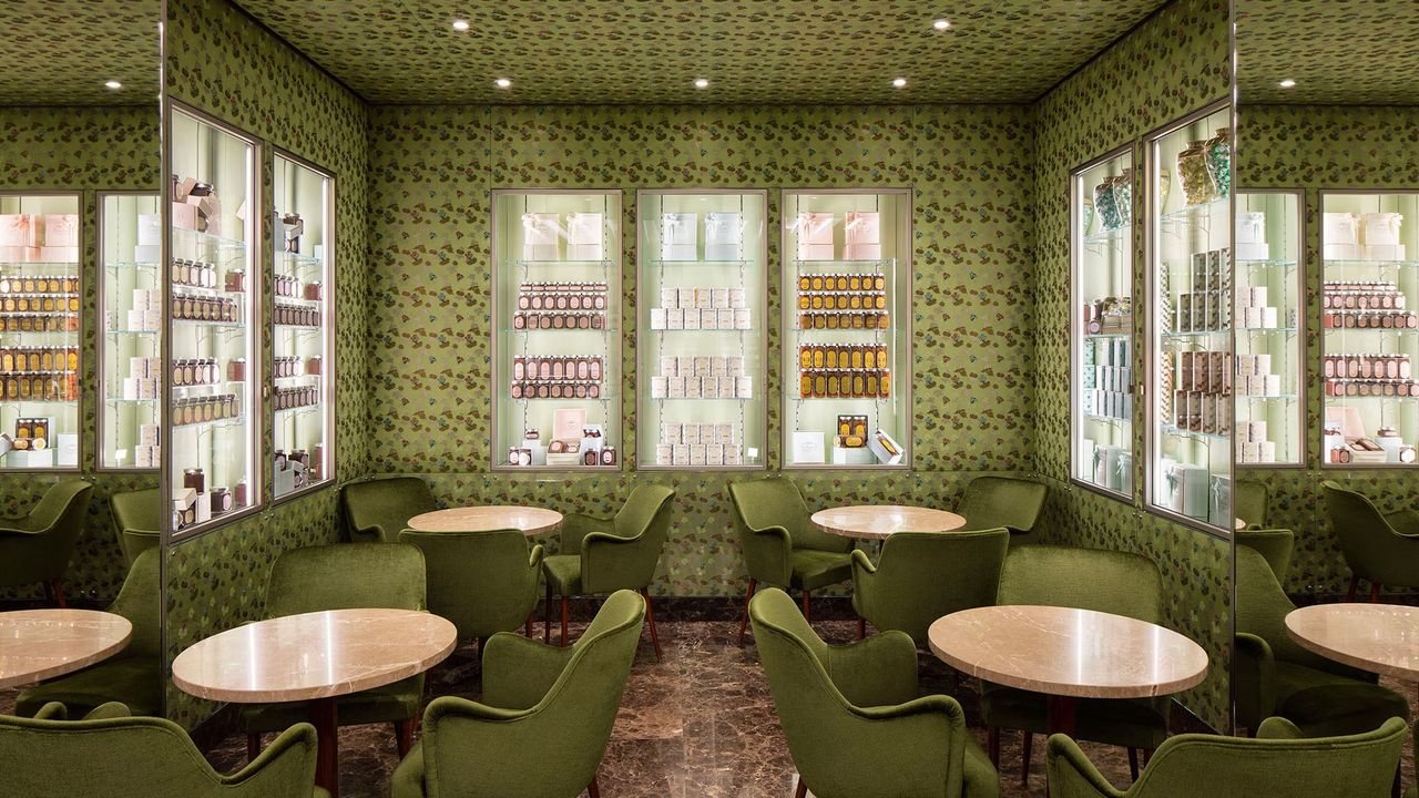 A vintage-inspired cafe and patisserie features whimsical green wallpaper and Art Deco furniture.