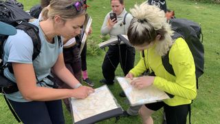 A group of hikers examine a map