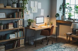 A modern office with a computer and desk set up at a home