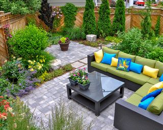 paved patio with plants and sofa