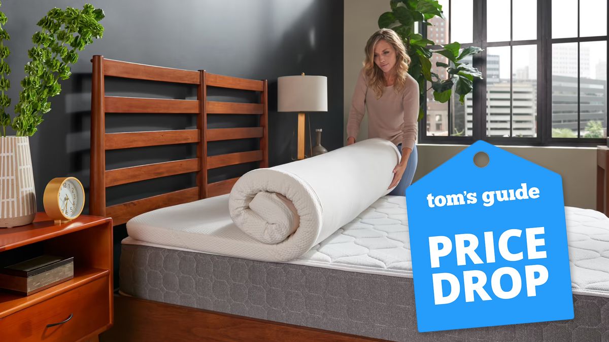 A woman rolls out the Tempur-Pedic Tempur Adapt topper on her mattress, with a price drop bade overlaid in blue