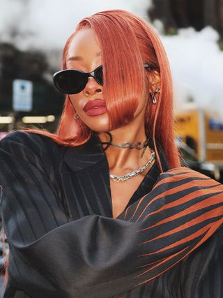 Content creator Nyane Lebajoa wears scarlet hair and matte red lips to New York Fashion Week