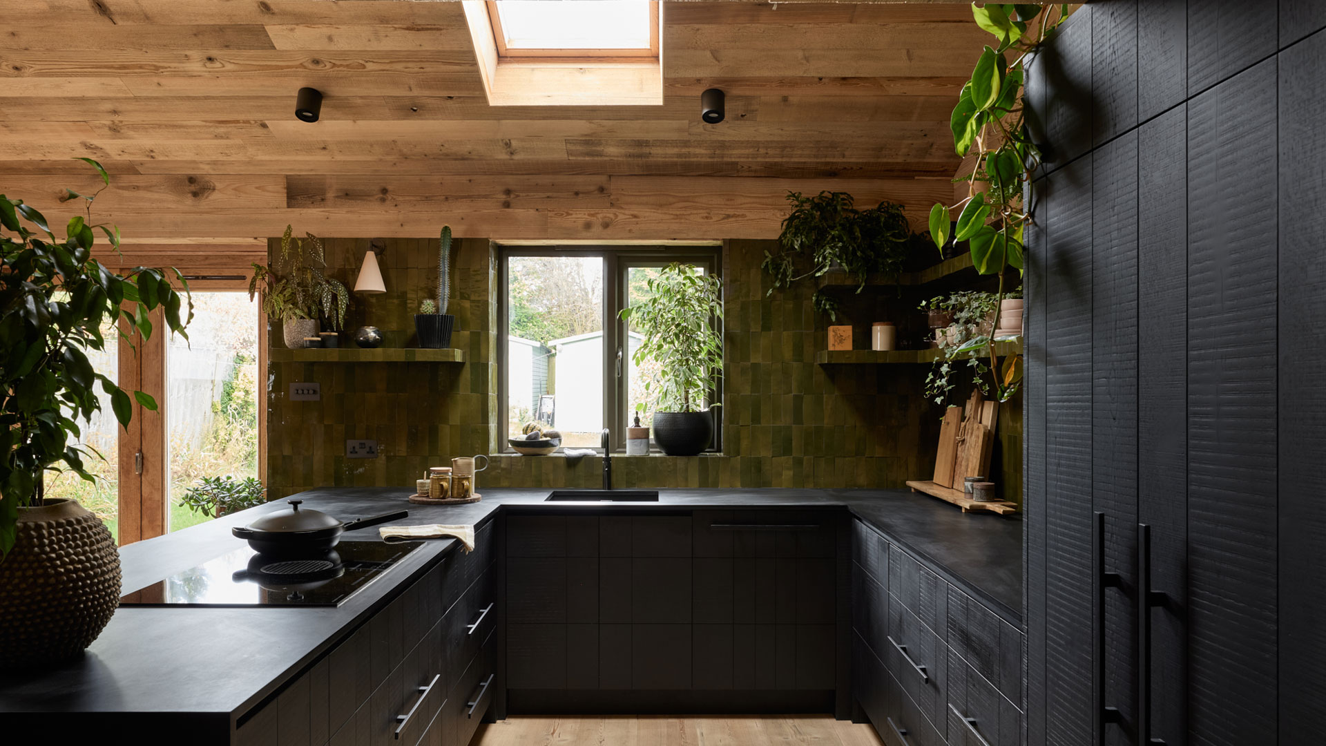 black stained wooden kitchen with wooden ceiling panelling