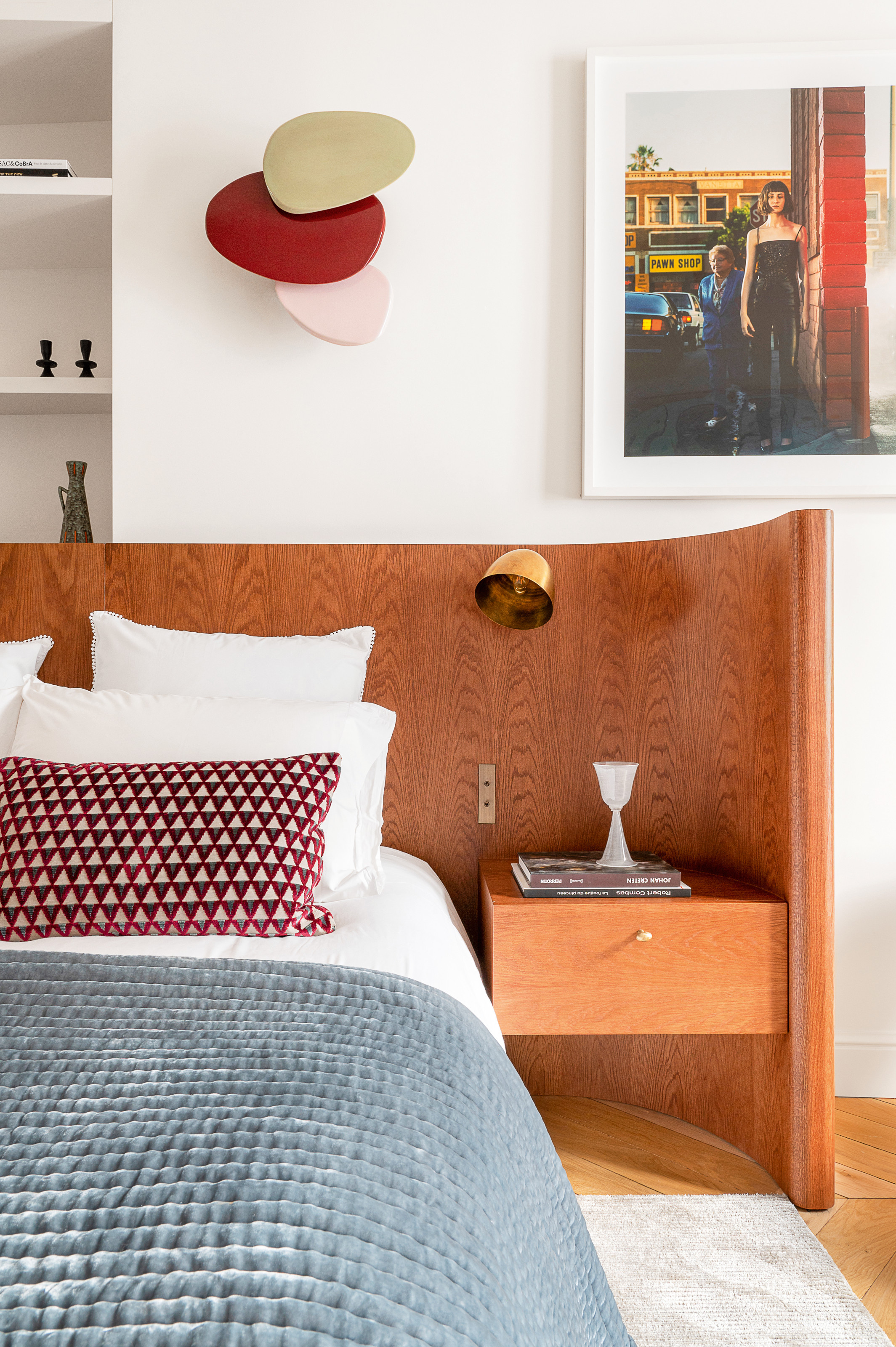 White bedroom with wood wraparound extended headboard