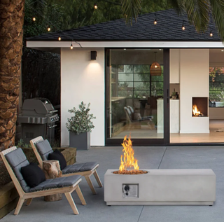 Outdoor fireplace on patio area with two chairs