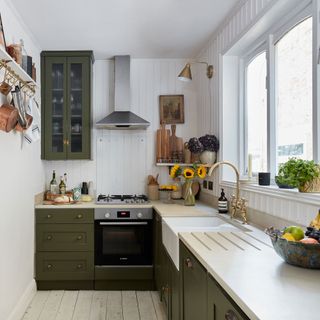 Green galley style kitchen with white work surface