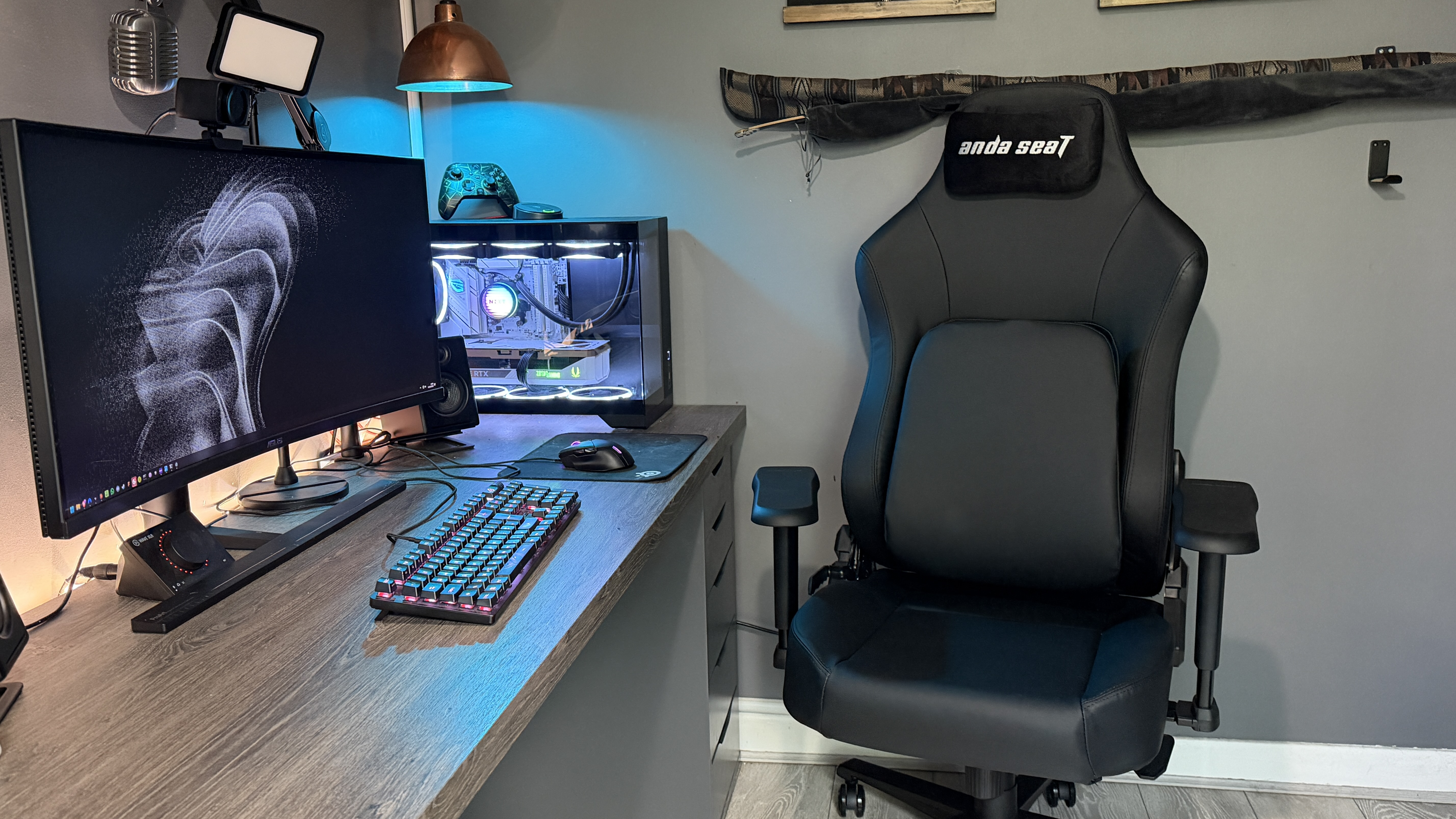 The AndaSeat Phantom 4 Pro in a brightly lit home office environment in front of a gaming PC.