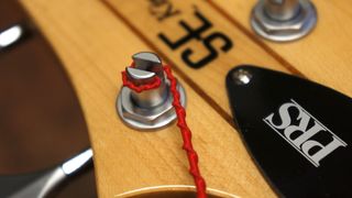 Winding strings on to a bass guitar tuning post