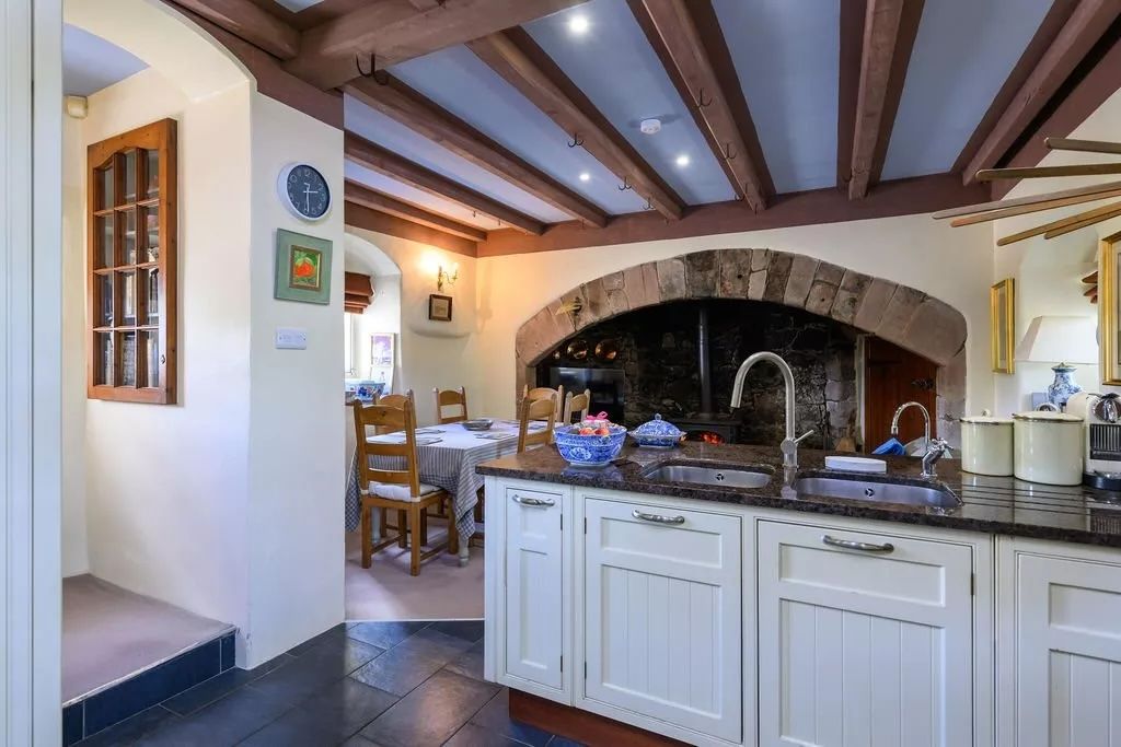 A view of the kitchen, with its massive stone fireplace