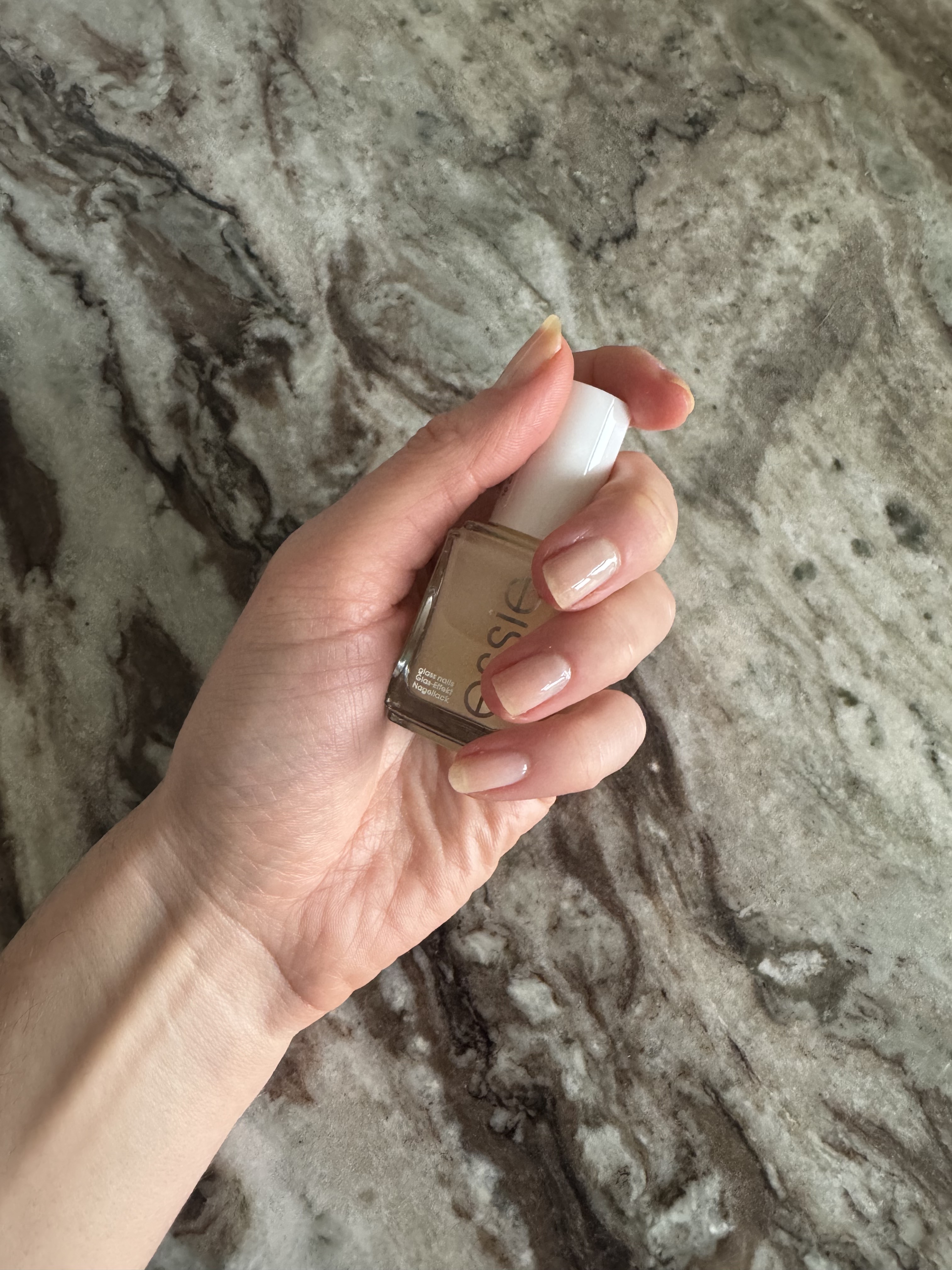 Eleanor's nails painted with three coats of Essie Glass Nails polish in Crystal Ball